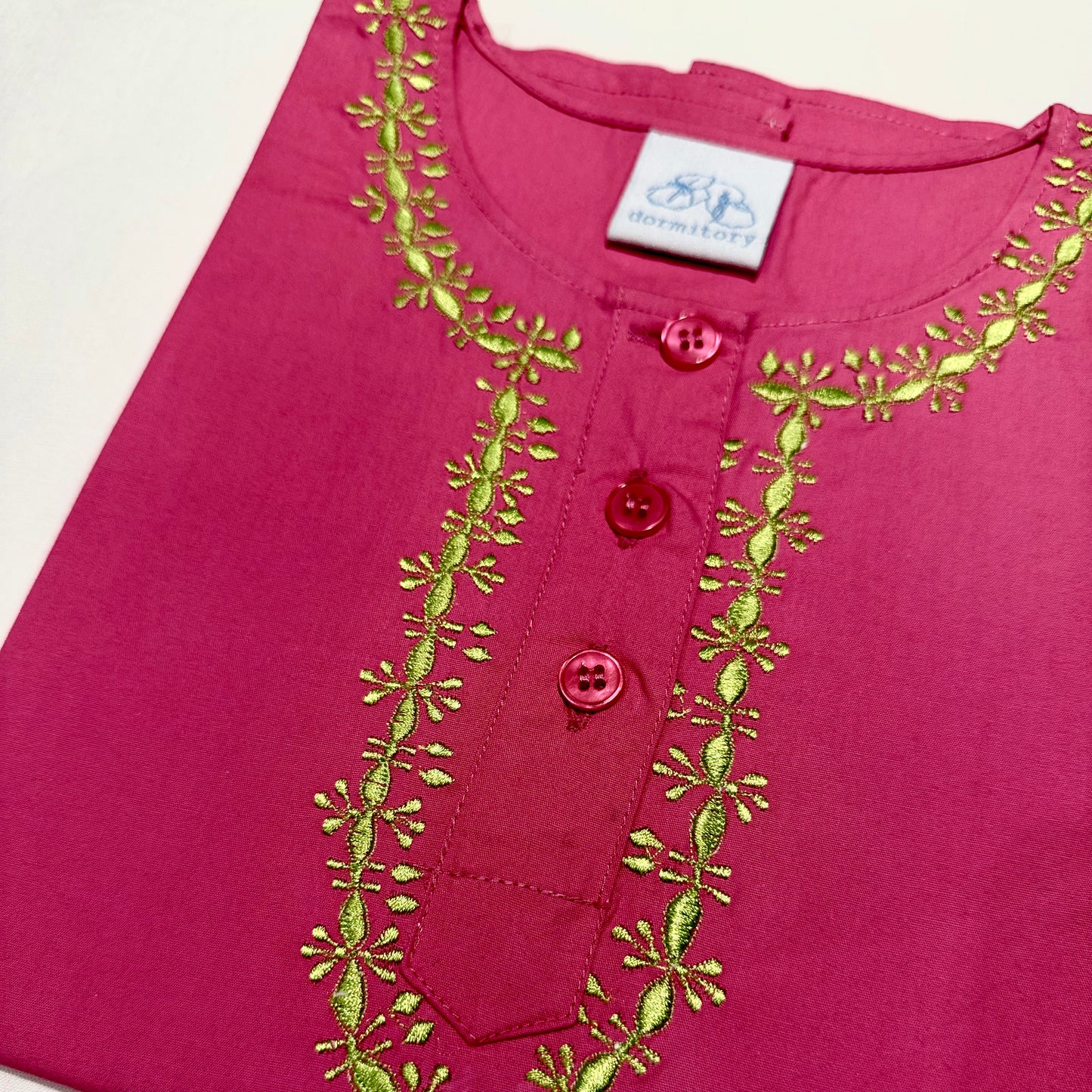 Pink pyjamas  in pure cotton with lime embroidery around the neck.