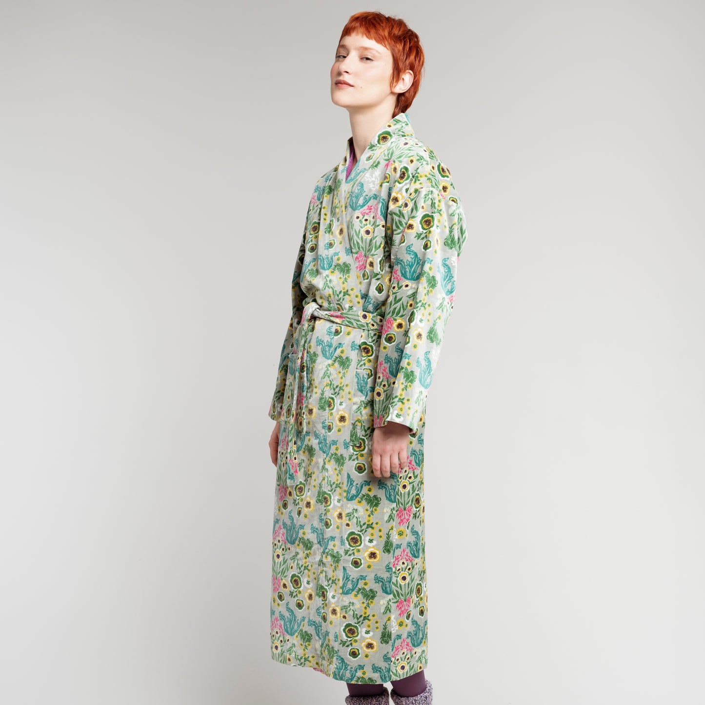 Cotton velvet robe with green, yellow, teal and pink wild flower design on a sage green base.