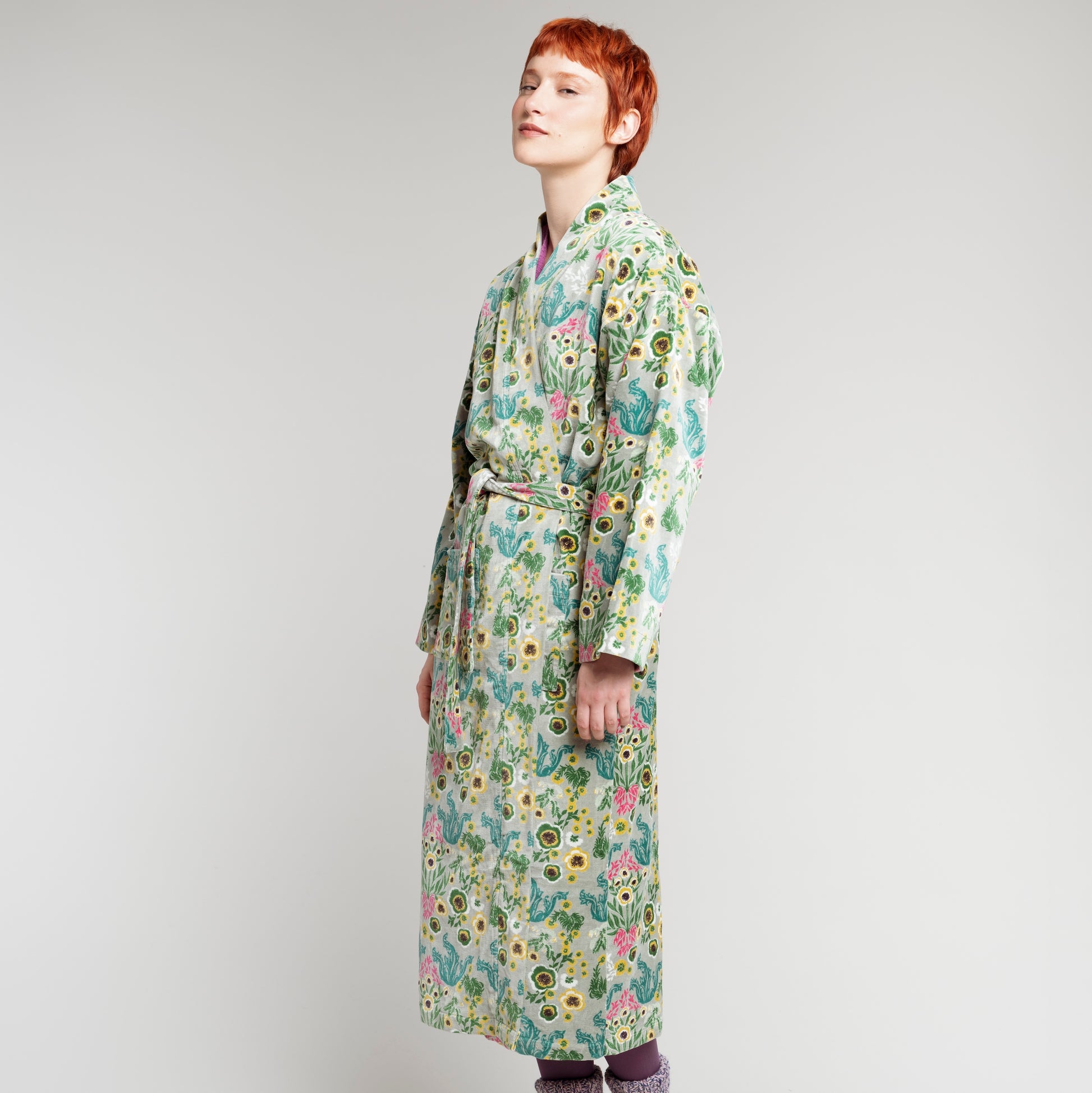 Cotton velvet robe with green, yellow, teal and pink wild flower design on a sage green base.