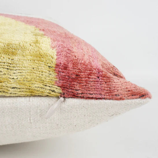 Pink and grey velvet ottoman cushion with feather pad.