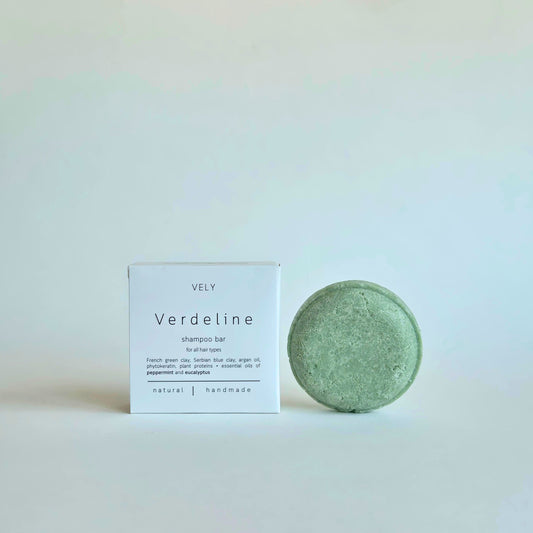 A round, light green shampoo bar next to its white packaging box labeled 'VELY Verdeline shampoo bar' on a clean, light off-white background.