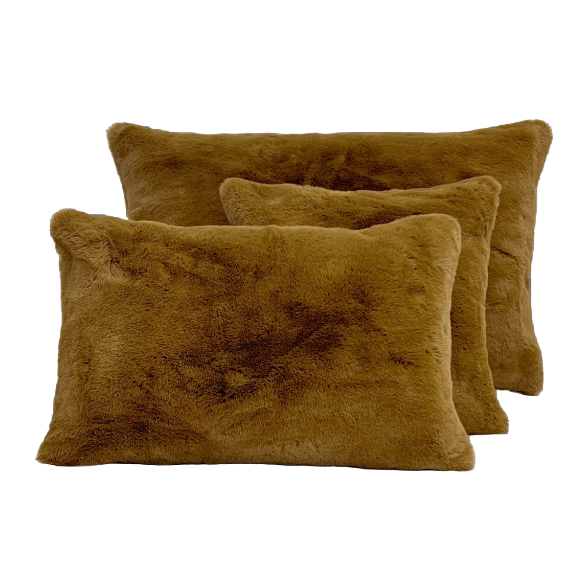 Three rectangular faux fur throw pillows in a warm camel brown color, arranged in a layered stack on a solid white background.