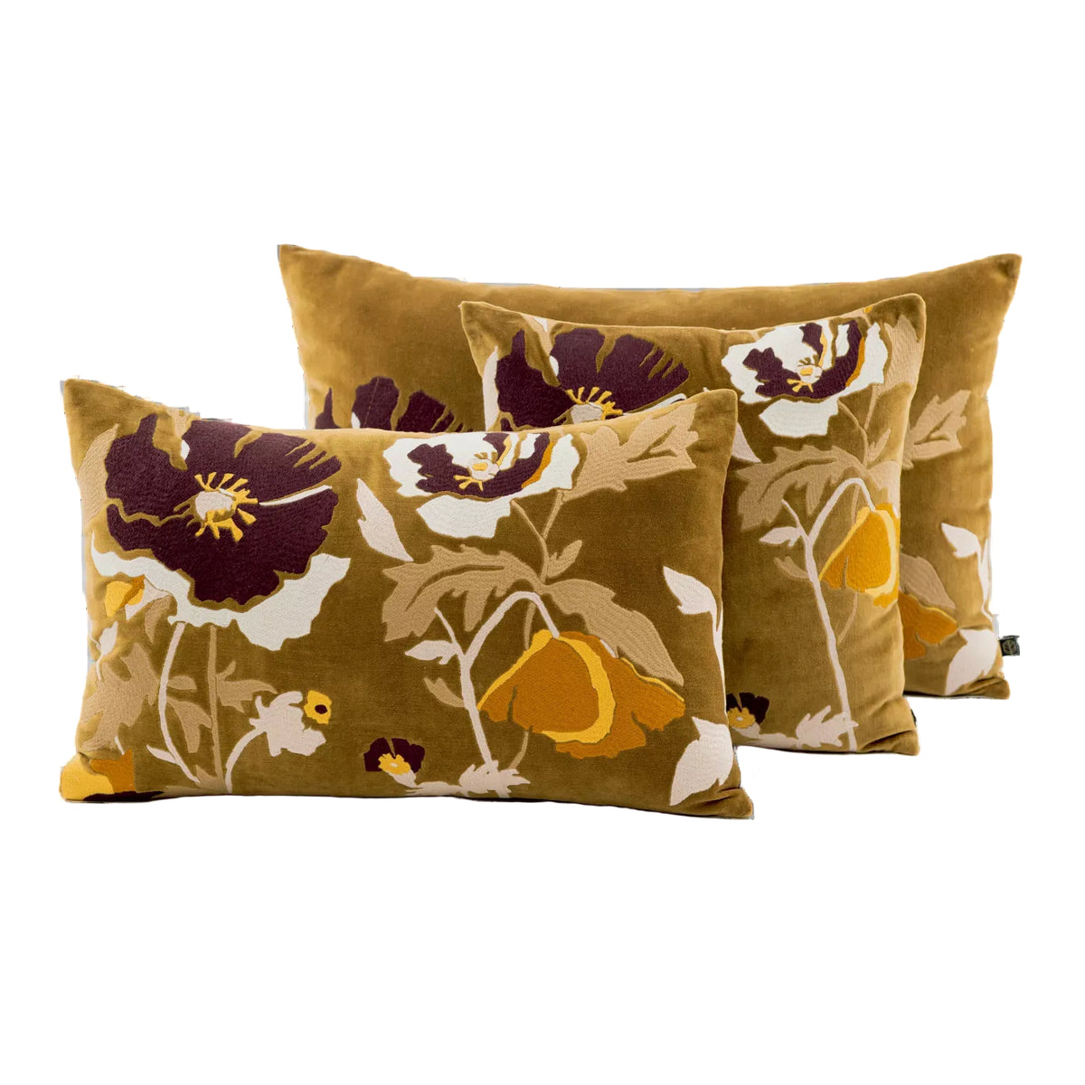 Three rectangular throw pillows in a matching floral set, featuring a mustard yellow velvet-like background with large dark purple, cream, and mustard yellow flowers, shown on a plain white background.