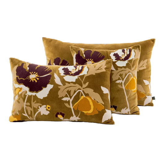 Three rectangular throw pillows in a matching floral set, featuring a mustard yellow velvet-like background with large dark purple, cream, and mustard yellow flowers, shown on a plain white background.