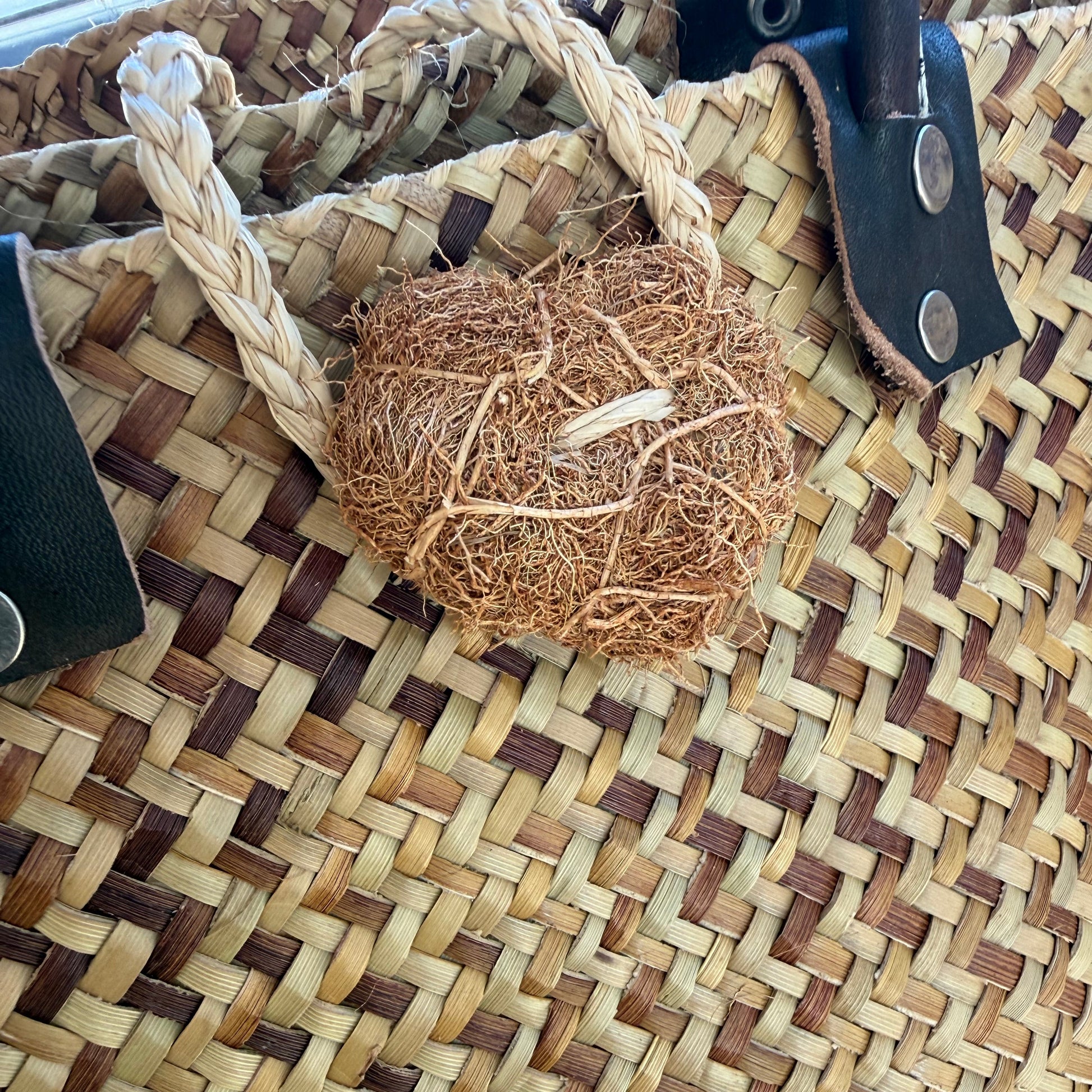 Palm fibre basket with vetiver button