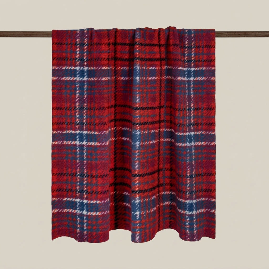 A red and purple plaid curtain panel hanging from a dark rod against a solid beige background.