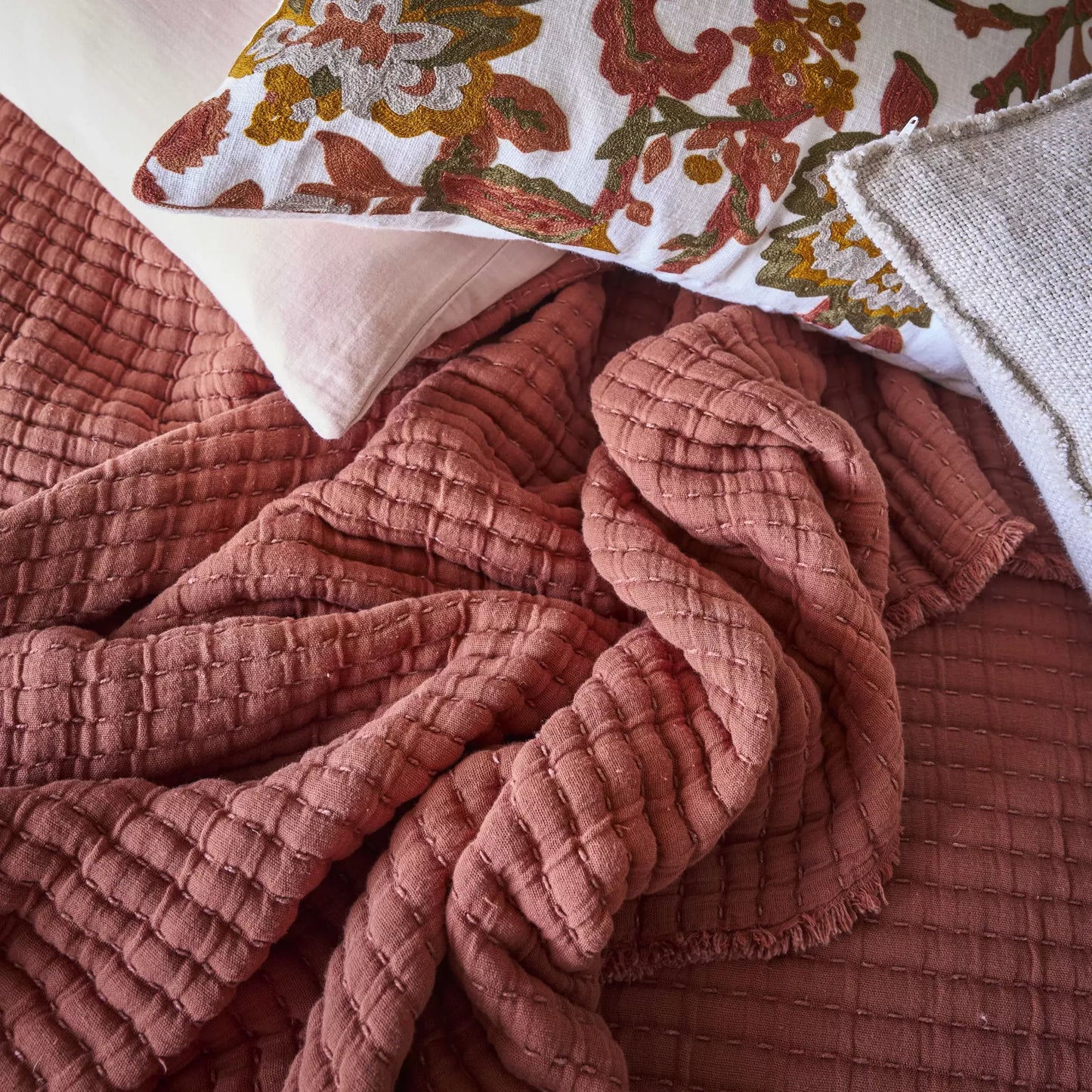 Tivoli bedspread in moccacino photographed on a bed.