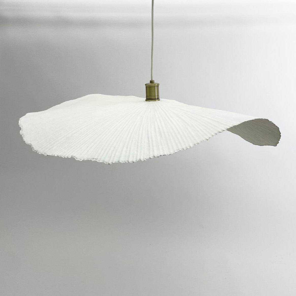 White pleated paper wave lampshade and fitting.